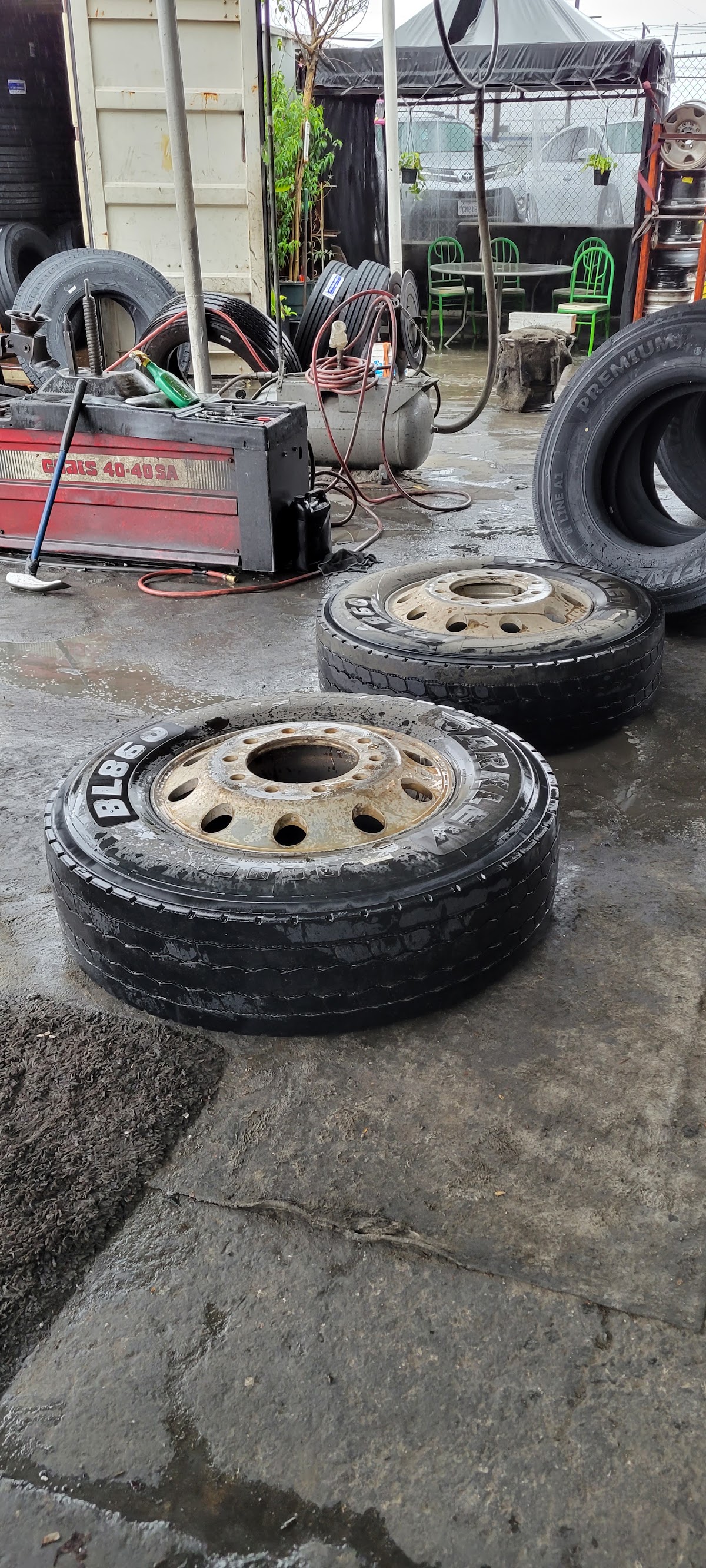 The Valley Commercial Tire yard, with a Coats commercial tire changer and mounted truck wheels
